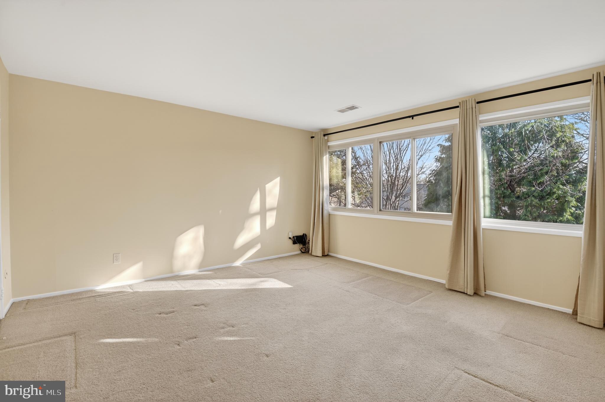 19144 Roman Way Gaithersburg, MD 20886 - Photo 17 of 31 a view of a big room with windows and chandelier fan