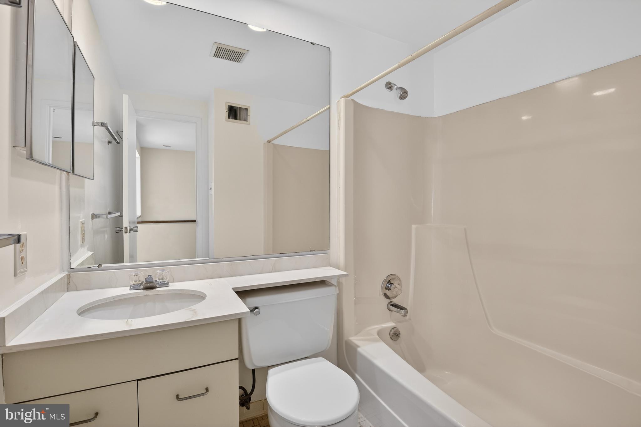19144 Roman Way Gaithersburg, MD 20886 - Photo 19 of 31 a bathroom with a sink toilet and shower