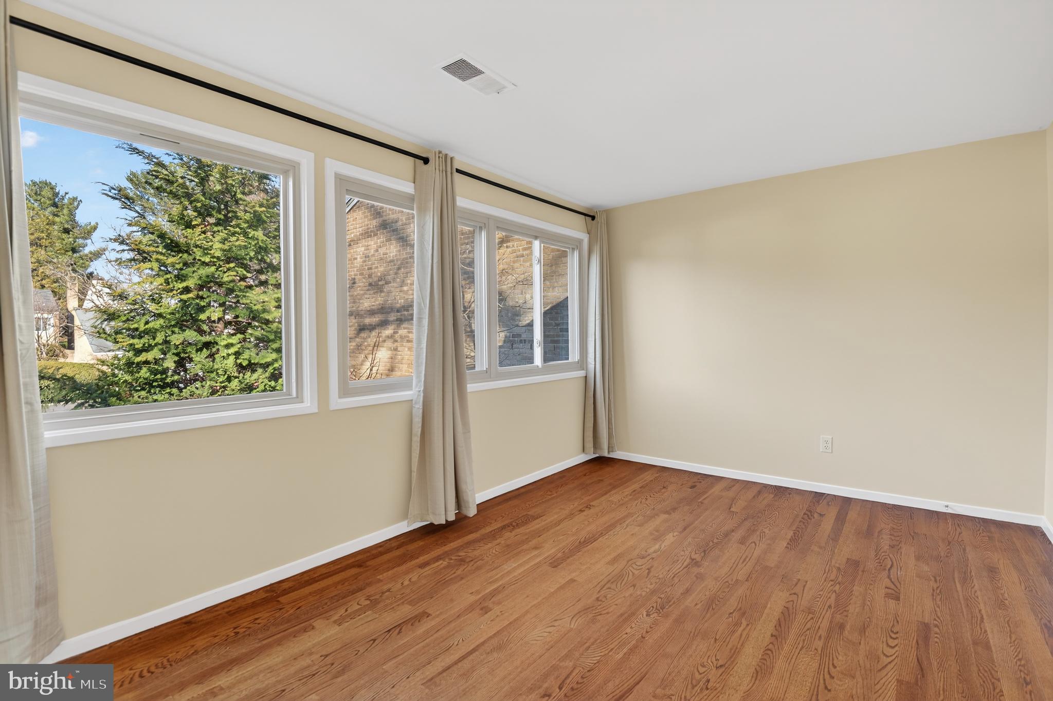 19144 Roman Way Gaithersburg, MD 20886 - Photo 20 of 31 a view of an empty room with wooden floor and a window