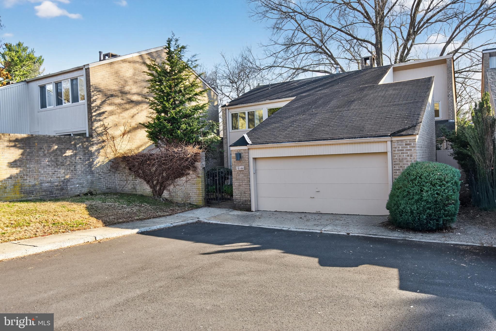 19144 Roman Way Gaithersburg, MD 20886 - Photo 2 of 31 a front view of a house with a yard and garage