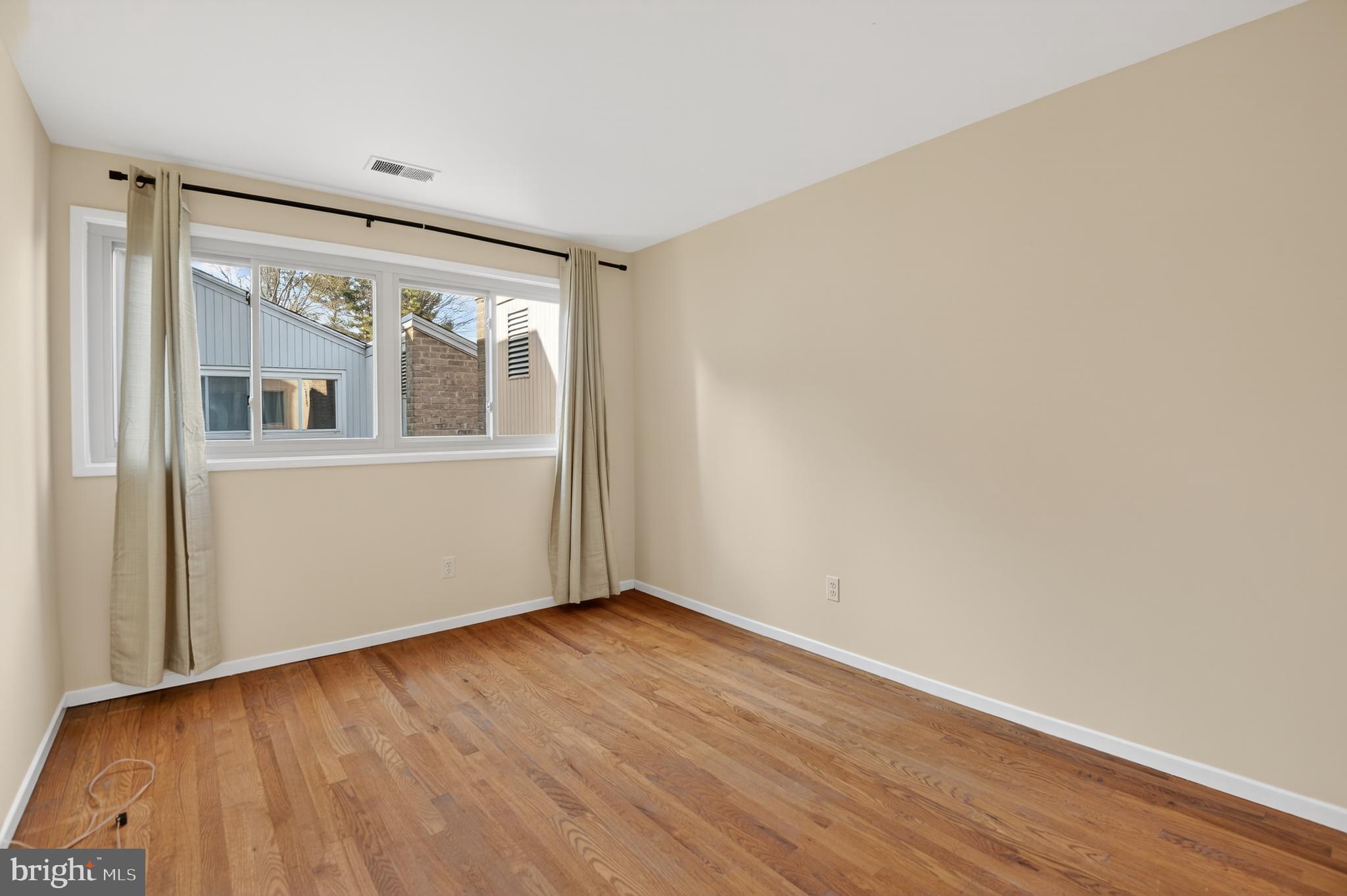 19144 Roman Way Gaithersburg, MD 20886 - Photo 21 of 31 an empty room with wooden floor and windows
