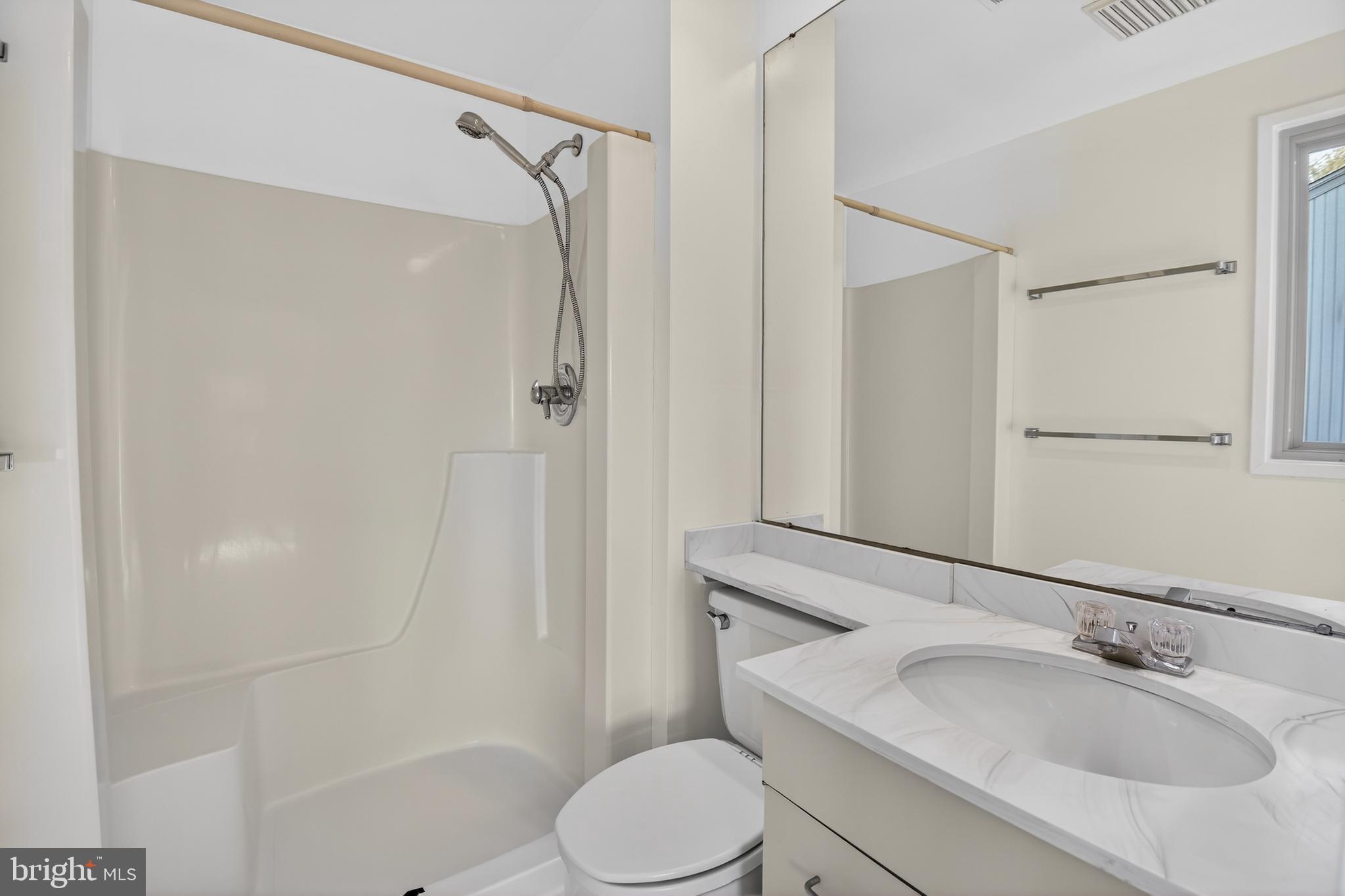 19144 Roman Way Gaithersburg, MD 20886 - Photo 24 of 31 a bathroom with a sink toilet and shower