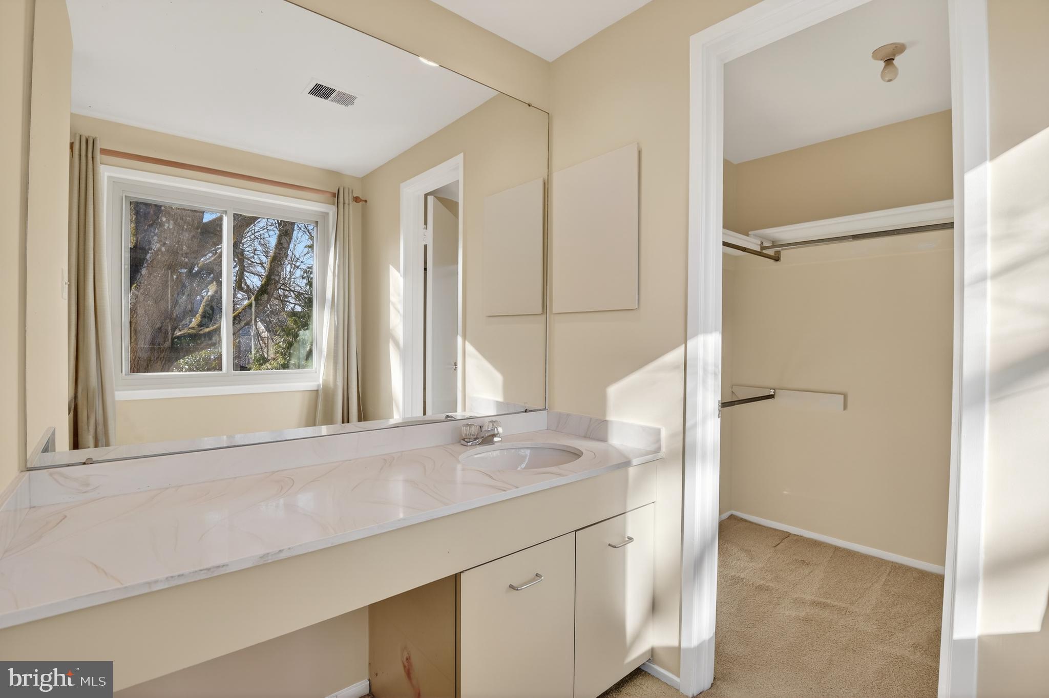 19144 Roman Way Gaithersburg, MD 20886 - Photo 25 of 31 a bathroom with a granite countertop sink mirror and window