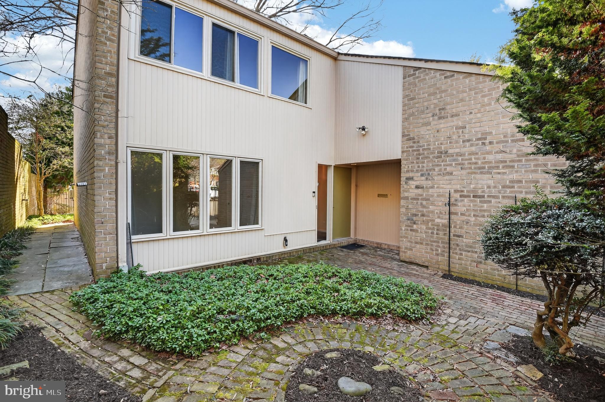 19144 Roman Way Gaithersburg, MD 20886 - Photo 3 of 31 a front view of a house with a garden