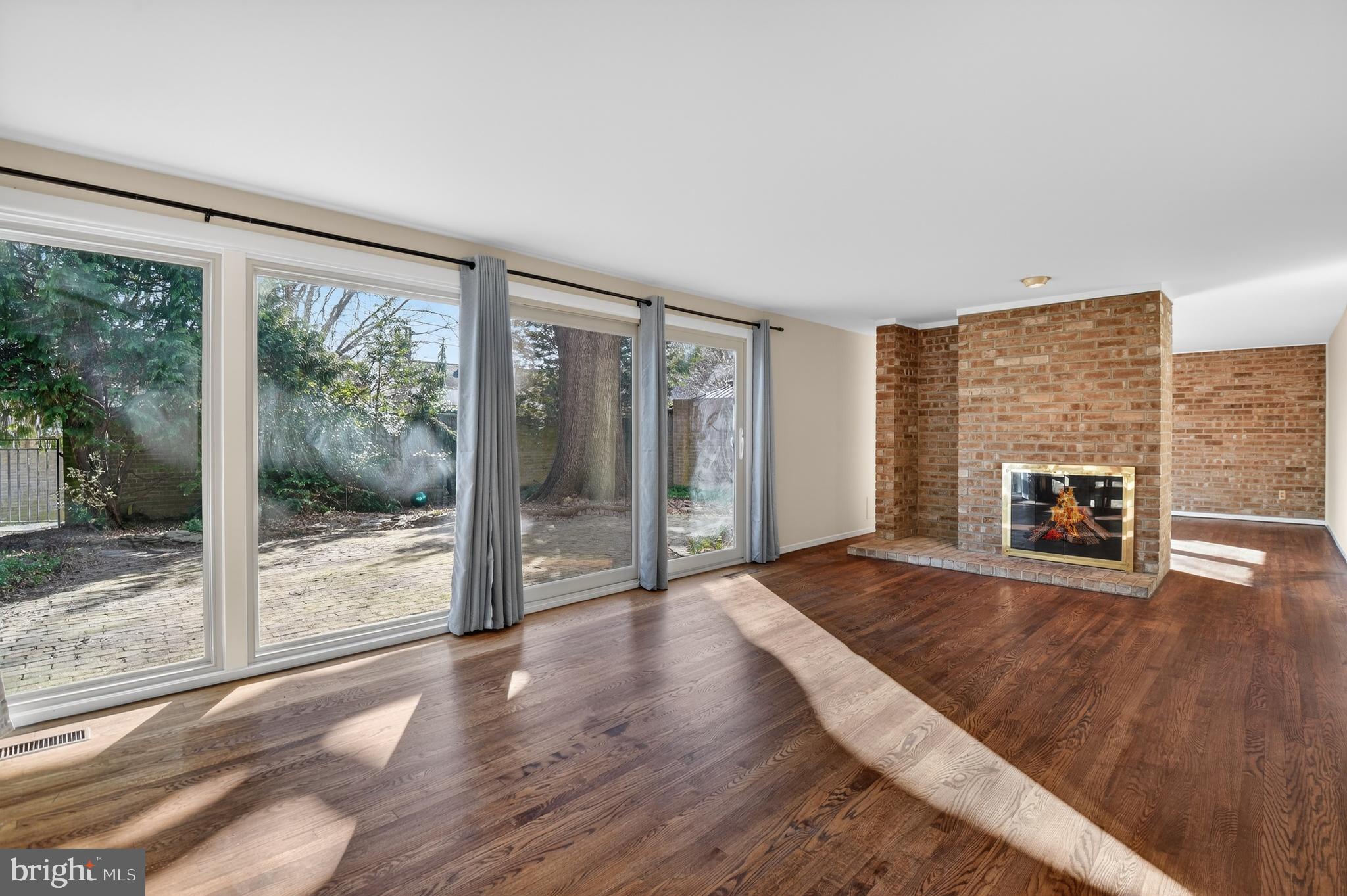 19144 Roman Way Gaithersburg, MD 20886 - Photo 6 of 31 a view of an empty room with wooden floor and a fireplace