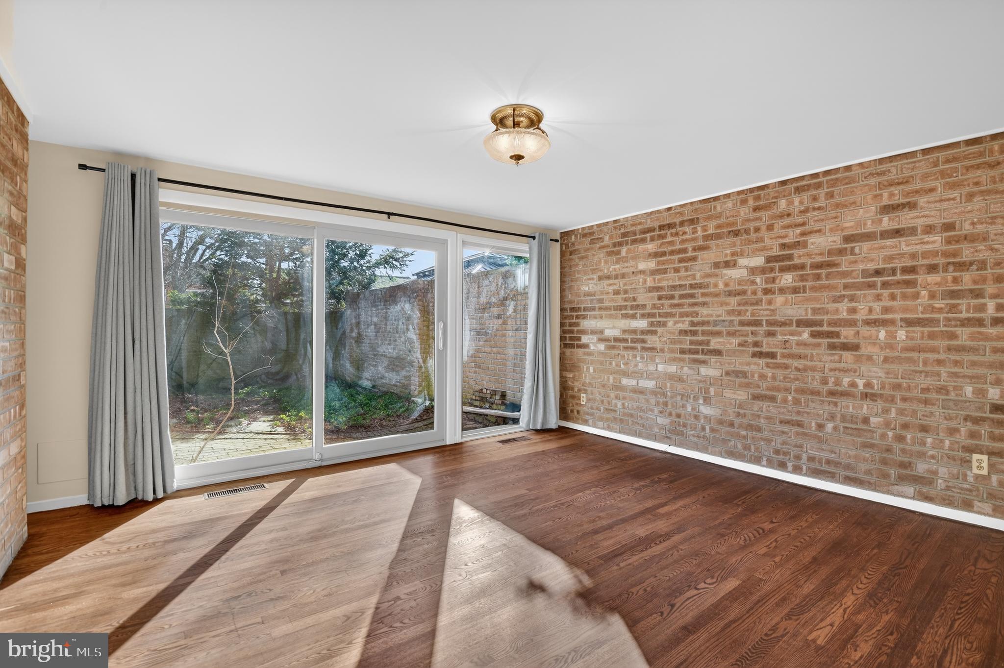 19144 Roman Way Gaithersburg, MD 20886 - Photo 8 of 31 a view of an empty room with wooden floor and a window