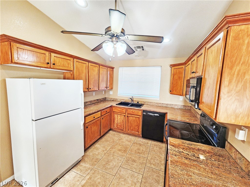 3680 Ravine Avenue Pahrump, NV 89048 - Photo 9 of 28 Kitchen with vaulted ceiling, a ceiling fan, a sink, black appliances, and visible vents