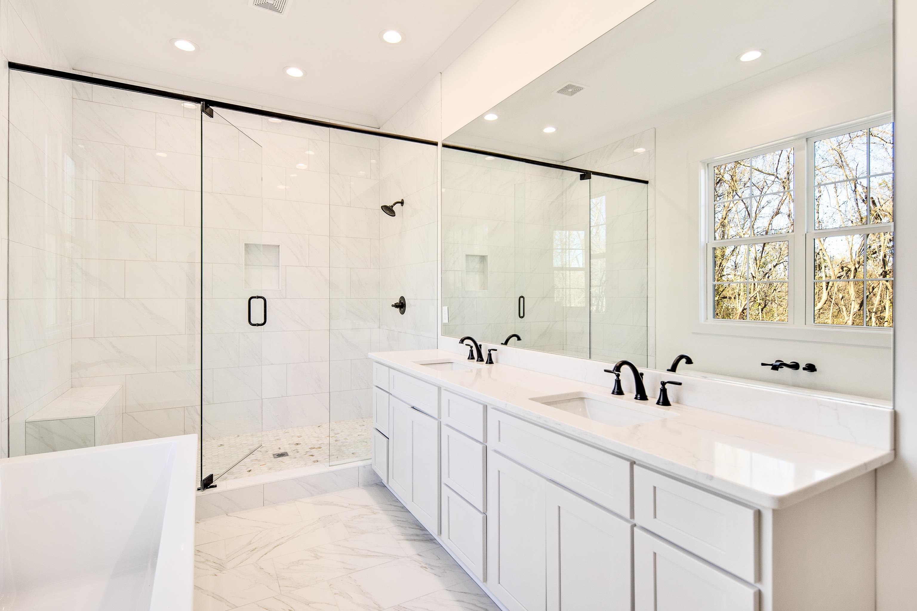 641 Fletcher Road Collierville, TN 38017 - Photo 16 of 39 a bathroom with a double vanity sink a mirror and a shower
