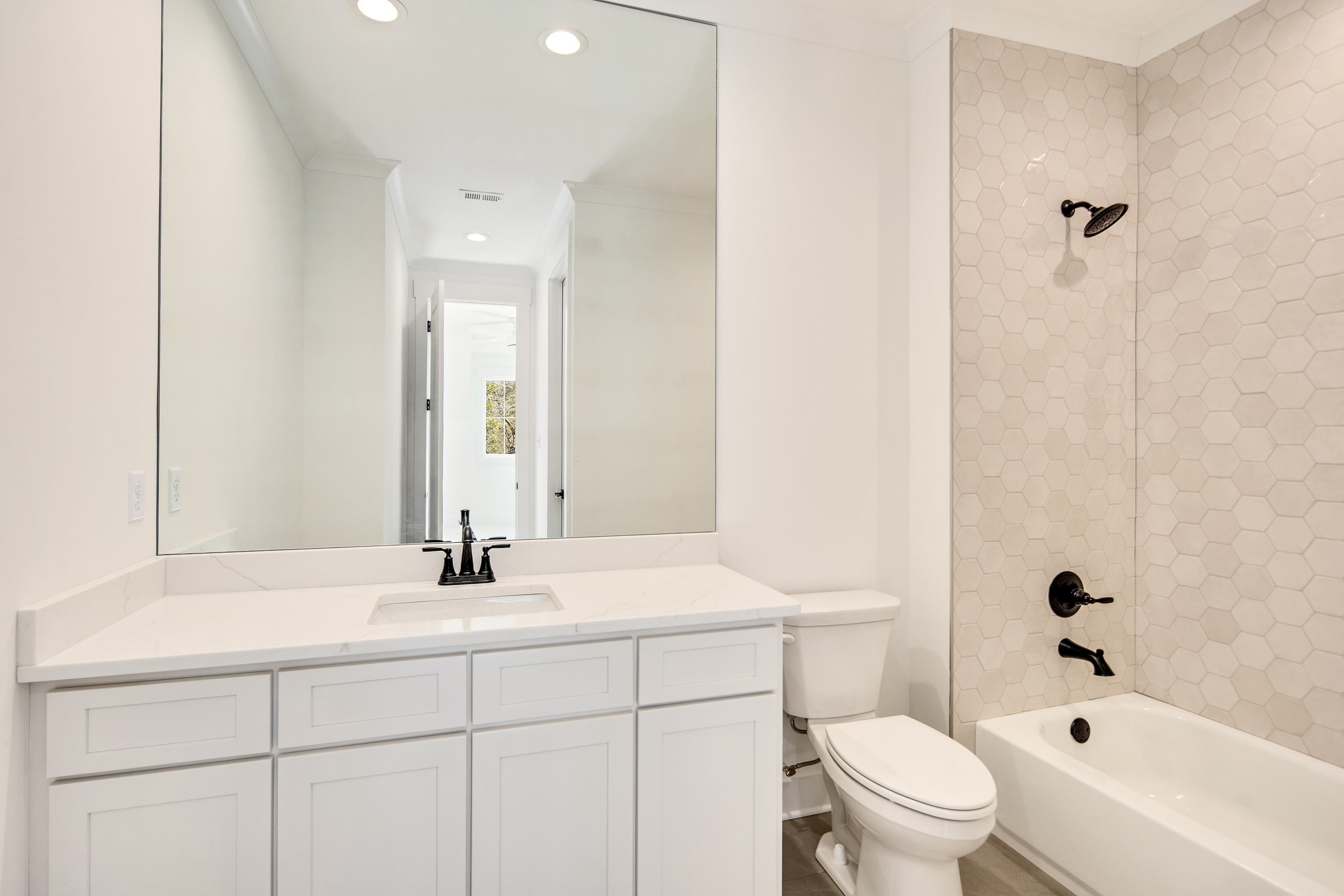 641 Fletcher Road Collierville, TN 38017 - Photo 25 of 39 a bathroom with a bathtub shower sink vanity mirror and toilet