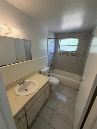 a bathroom with a sink a toilet and mirror