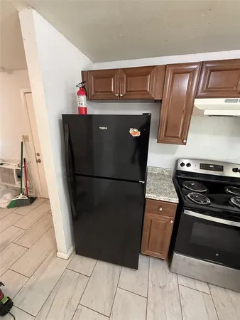a view of a refrigerator in kitchen