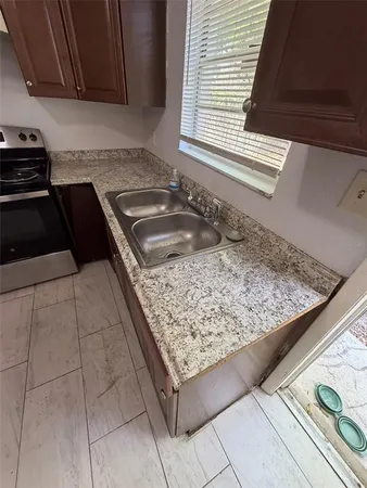 a kitchen with a sink a stove and a microwave oven