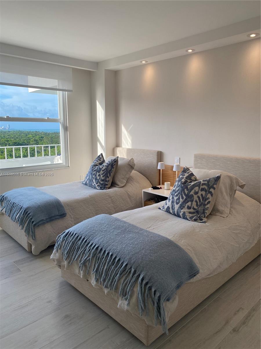 199 Ocean Ln Drive, Unit 1112 Key Biscayne, FL 33149 - Photo 11 of 36 a bedroom with two beds and a night stand