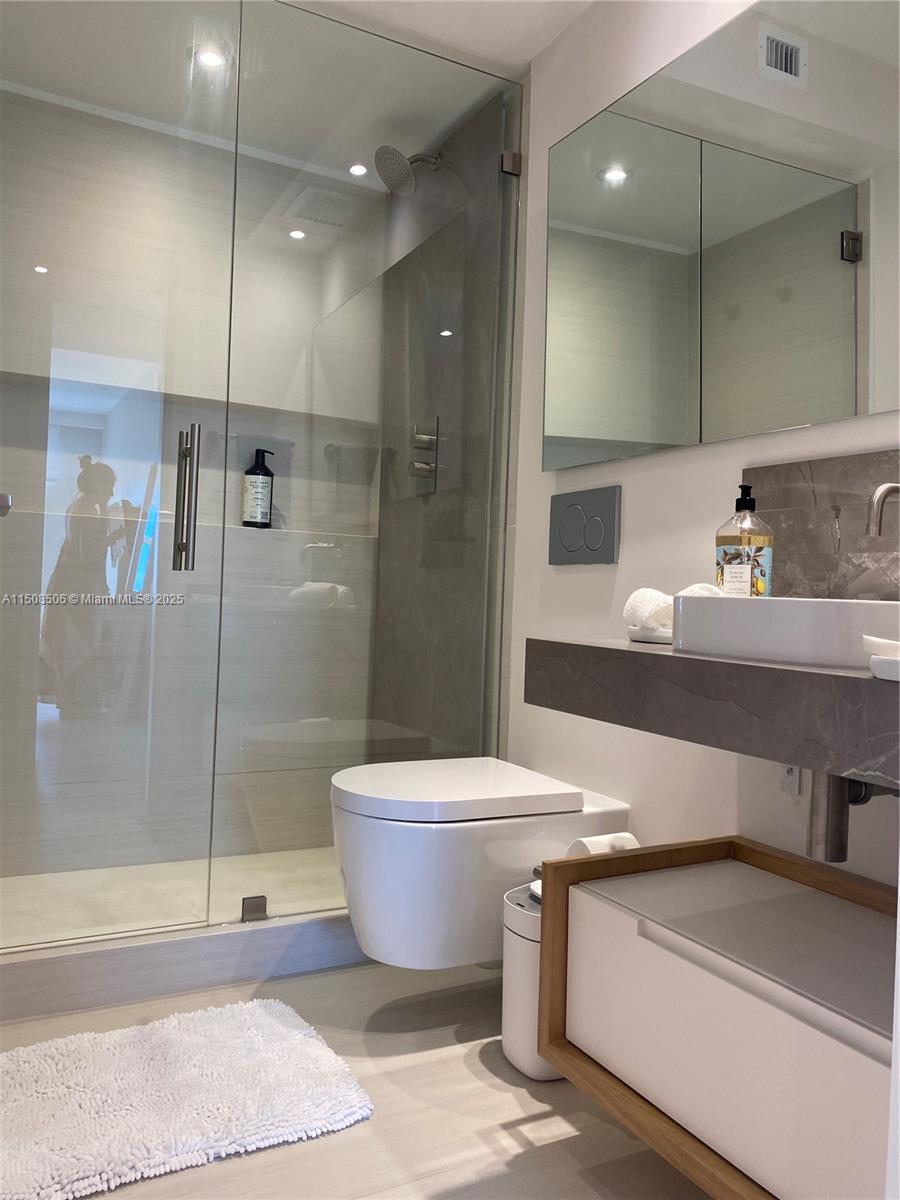 199 Ocean Ln Drive, Unit 1112 Key Biscayne, FL 33149 - Photo 12 of 36 a bathroom with a sink a toilet and shower