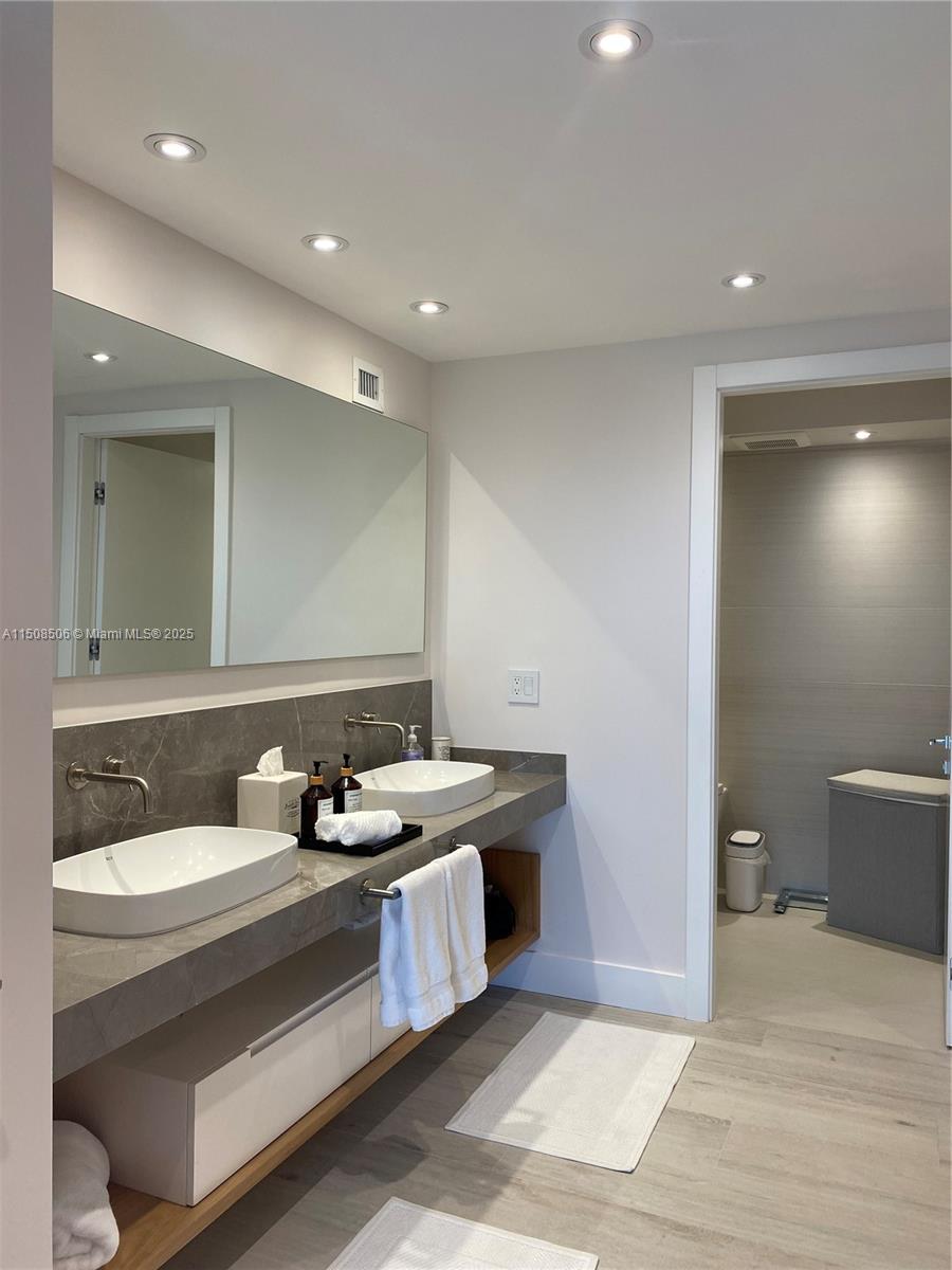 199 Ocean Ln Drive, Unit 1112 Key Biscayne, FL 33149 - Photo 15 of 36 a bathroom with a sink toilet and mirror