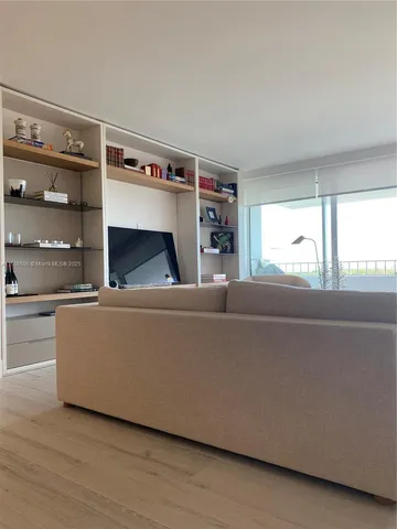 a bedroom with a bed and glass window