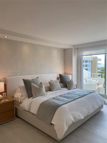 a living room with a bed and a large window