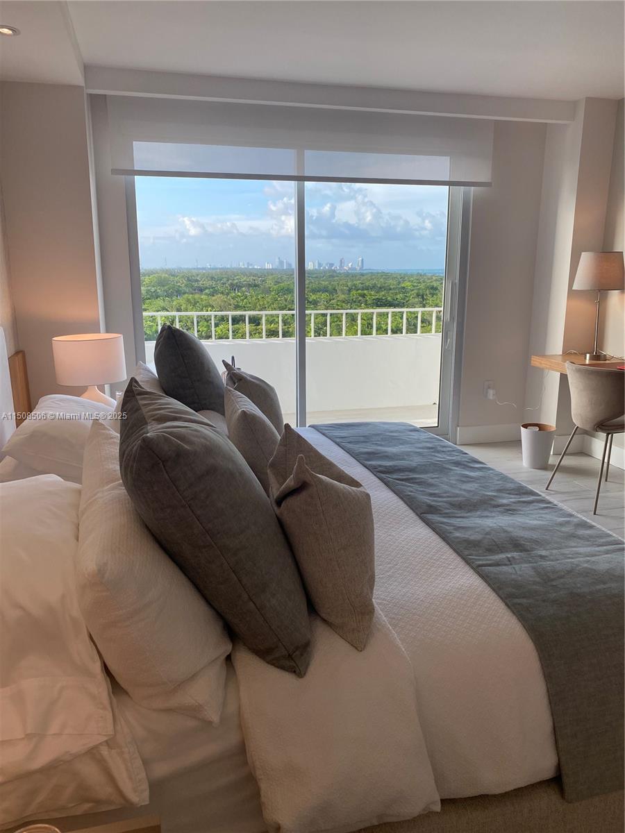 199 Ocean Ln Drive, Unit 1112 Key Biscayne, FL 33149 - Photo 21 of 36 a living room with a bed and a large window