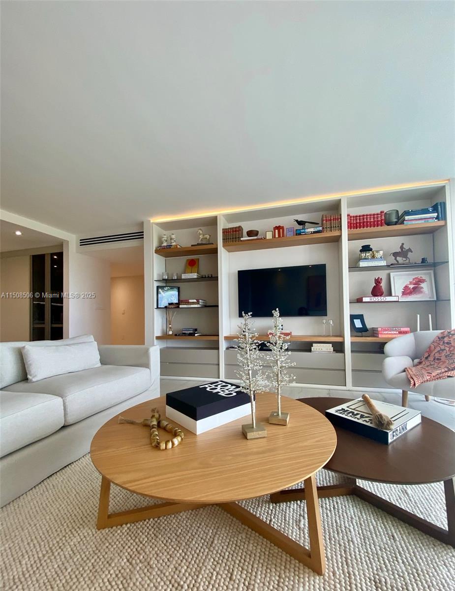 199 Ocean Ln Drive, Unit 1112 Key Biscayne, FL 33149 - Photo 28 of 36 a living room with furniture a flat screen tv and a table