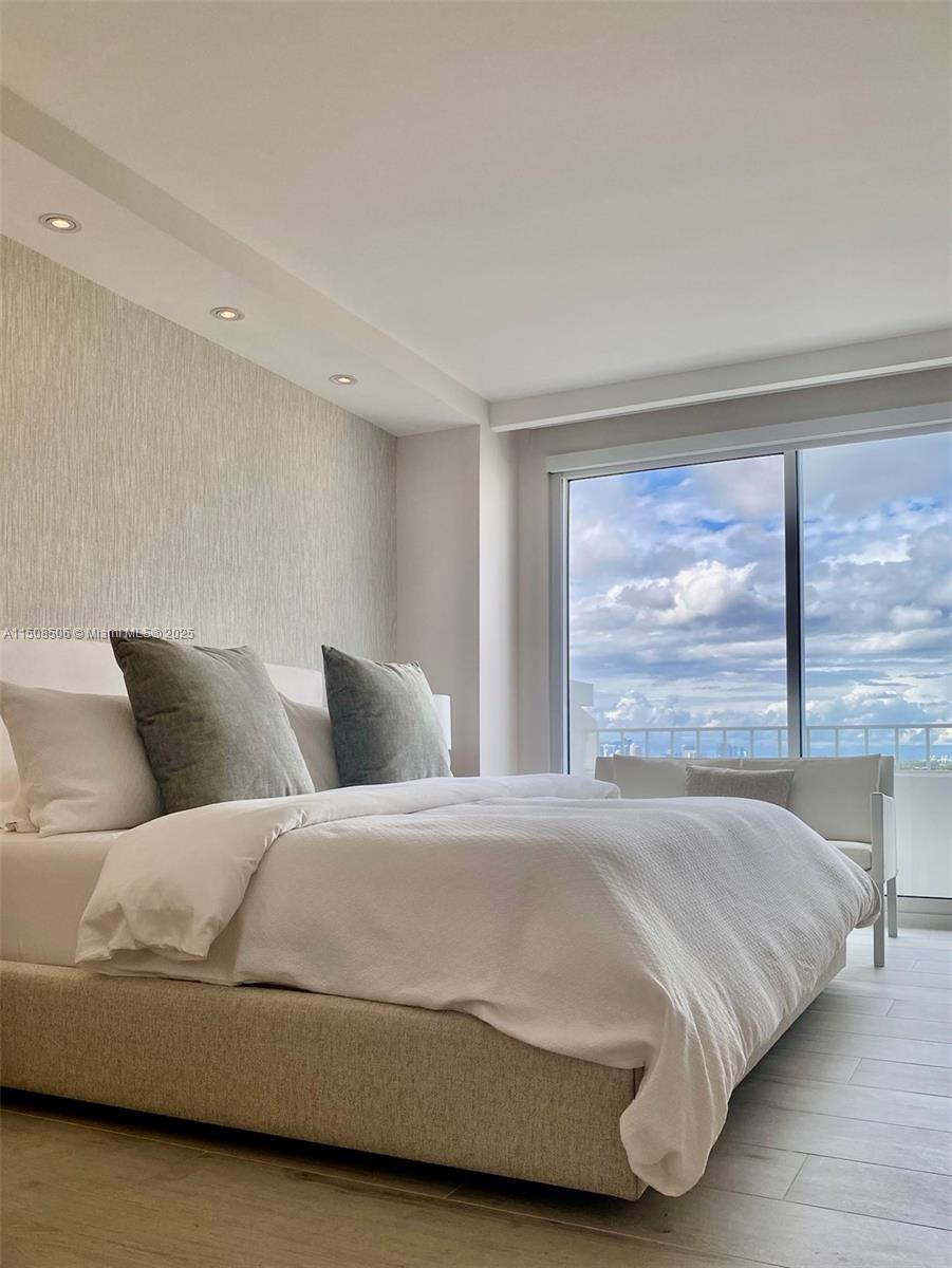199 Ocean Ln Drive, Unit 1112 Key Biscayne, FL 33149 - Photo 33 of 36 a bedroom with a large bed and a large window