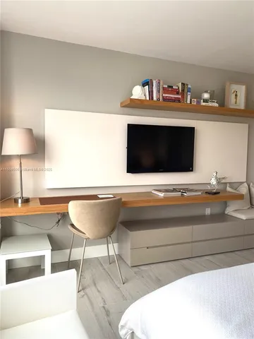 a bedroom with two beds and a window