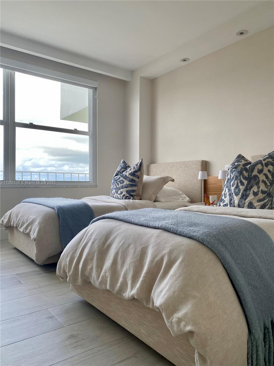 199 Ocean Ln Drive, Unit 1112 Key Biscayne, FL 33149 - Photo 35 of 36 a bedroom with two beds and a window