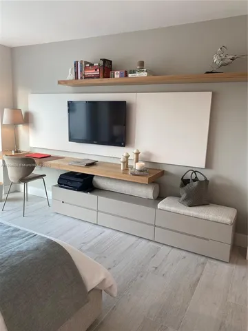 a living room with furniture and a floor to ceiling window