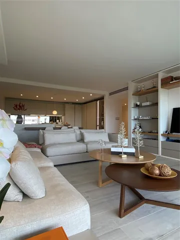 a kitchen with stainless steel appliances wooden floor and a sink