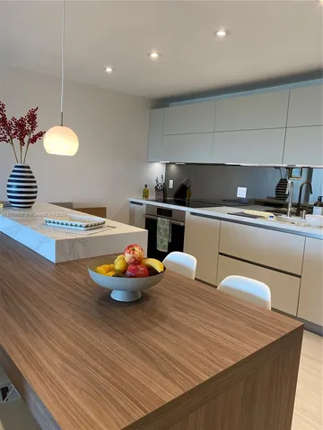 a kitchen with a table and chairs in it