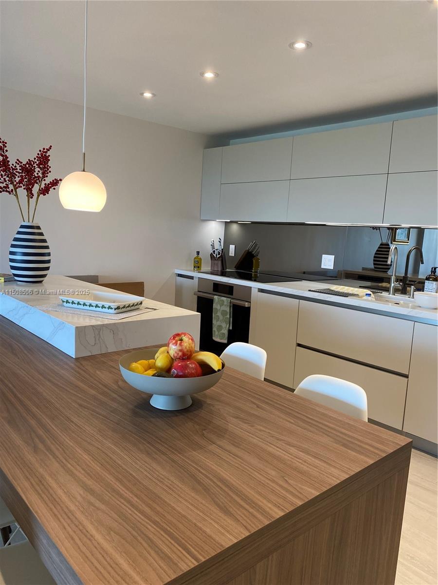 199 Ocean Ln Drive, Unit 1112 Key Biscayne, FL 33149 - Photo 8 of 36 a kitchen with stainless steel appliances wooden floor and a sink