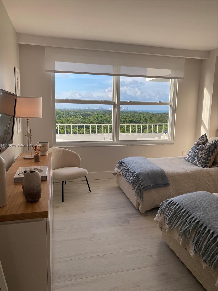 199 Ocean Ln Drive, Unit 1112 Key Biscayne, FL 33149 - Photo 10 of 36 a bedroom with furniture and a large window