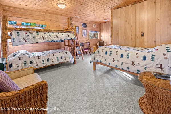 a patio with a table and chairs and potted plants