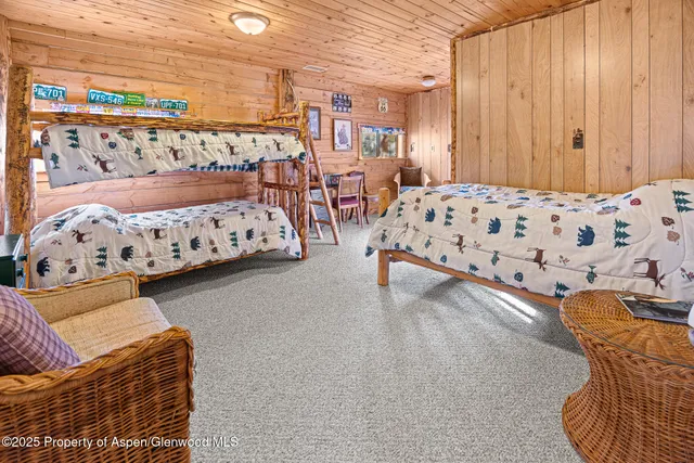 a patio with a table and chairs and potted plants