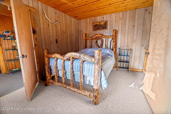 a bed sitting in a bedroom next to a large window