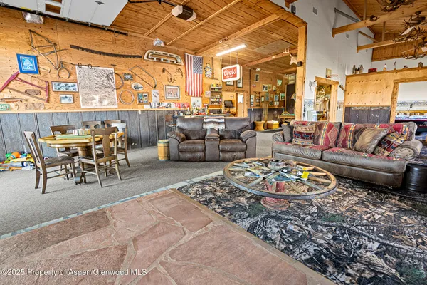 a living room with furniture rug and wooden floor