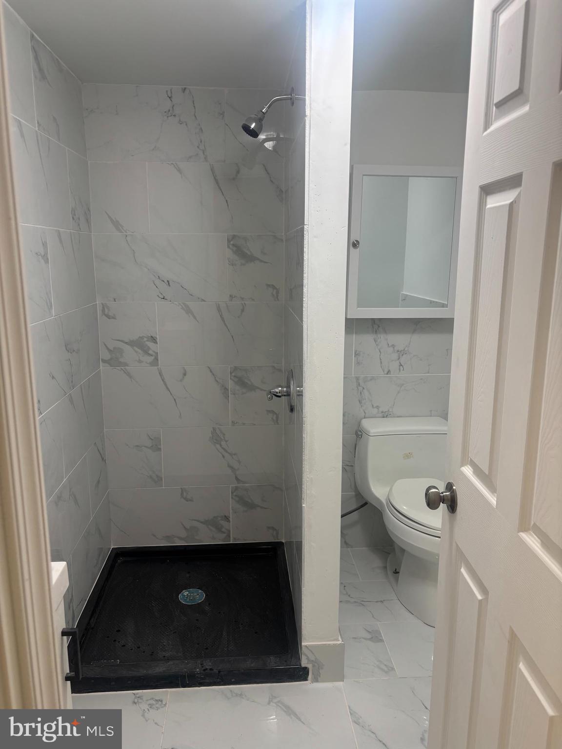 1623 West Lexington Street Baltimore, MD 21223 - Photo 14 of 26 a bathroom with a granite countertop toilet and a sink