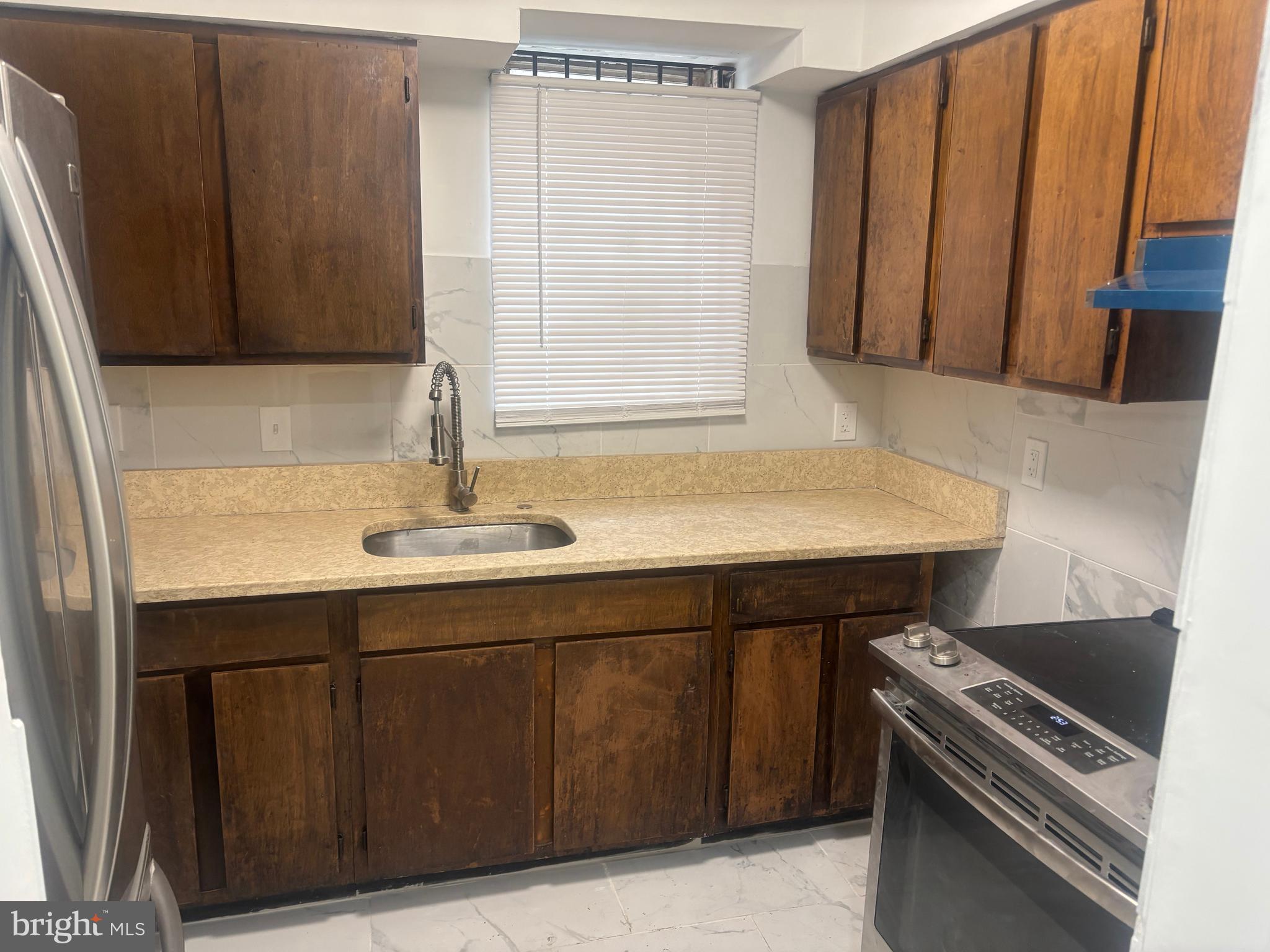 1623 West Lexington Street Baltimore, MD 21223 - Photo 25 of 26 a kitchen with a sink and a stove top oven