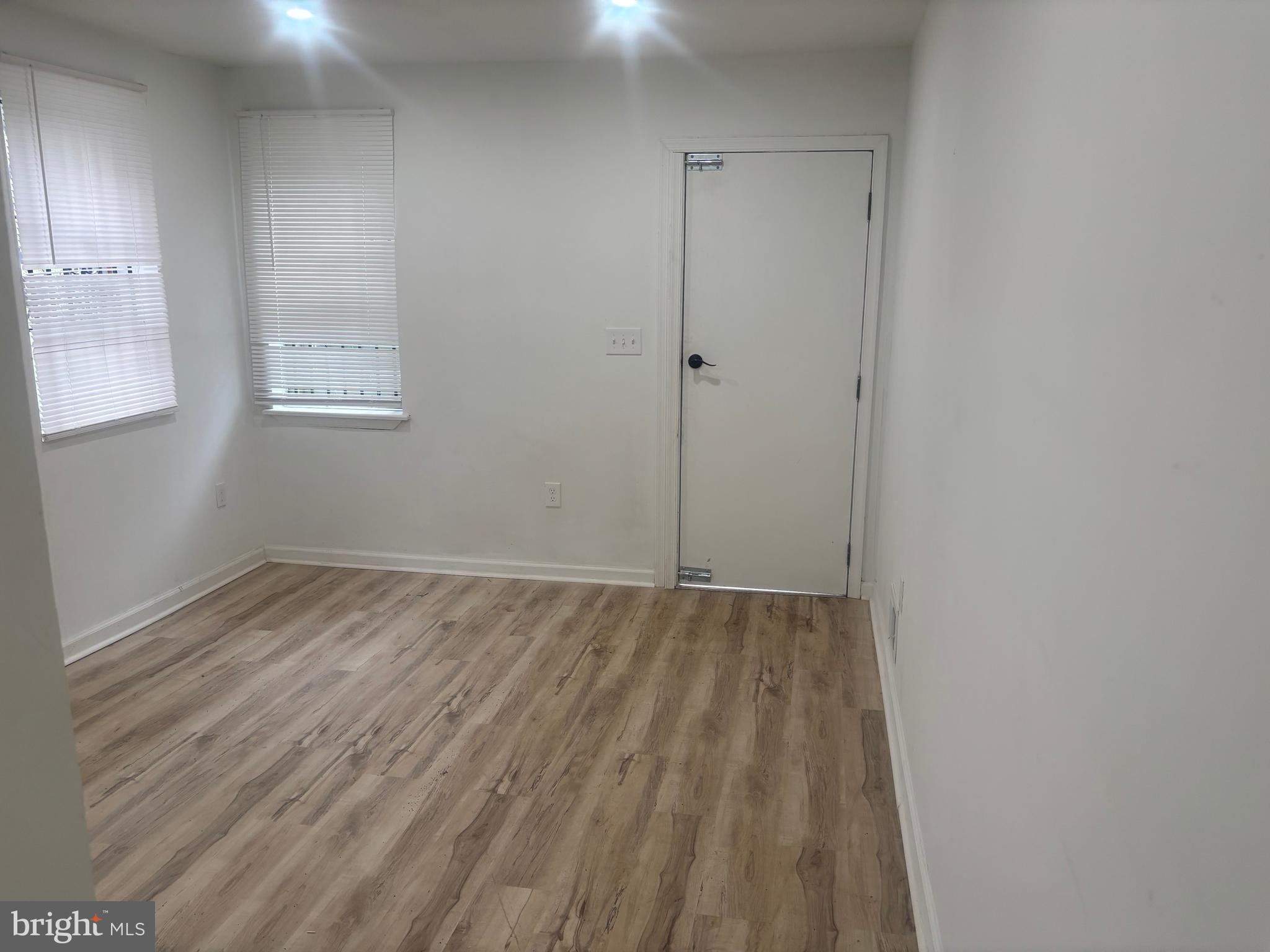 1623 West Lexington Street Baltimore, MD 21223 - Photo 26 of 26 a view of an empty room with wooden floor