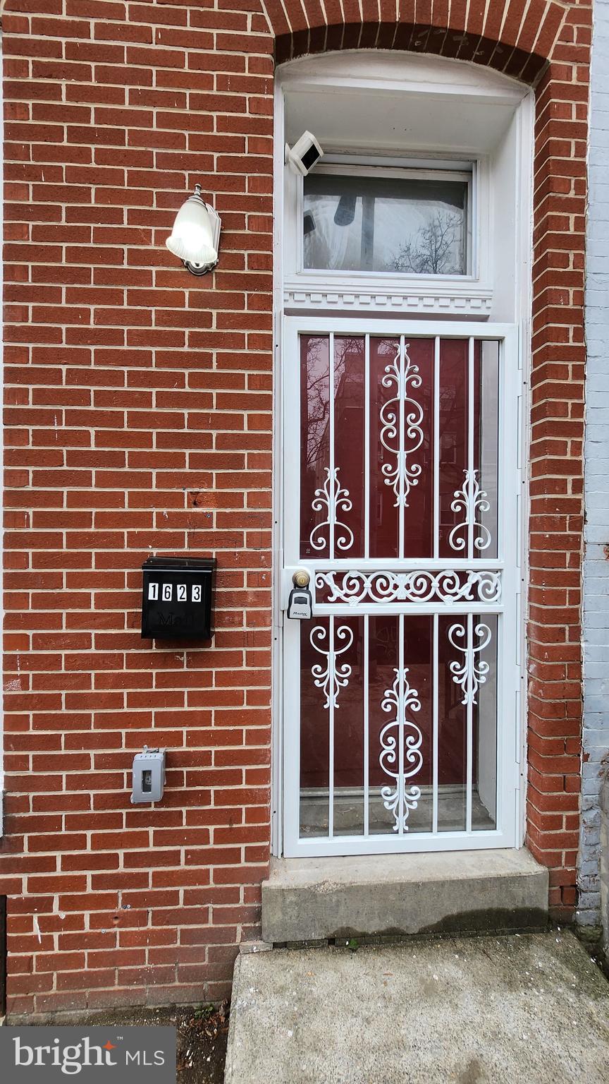 1623 West Lexington Street Baltimore, MD 21223 - Photo 7 of 26 a view of a brick house with large windows