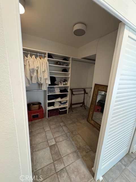 71942 Eleanora Lane Rancho Mirage, CA 92270 - Photo 19 of 31 a view of walk in closet with clothes and shoes