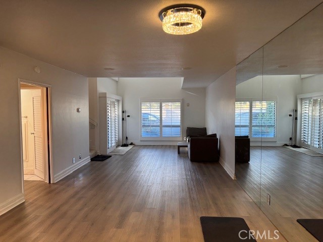 71942 Eleanora Lane Rancho Mirage, CA 92270 - Photo 3 of 31 an empty room with wooden floor and windows