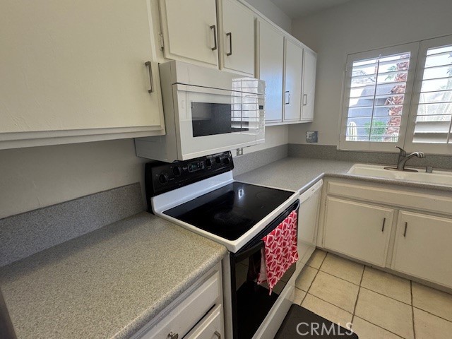 71942 Eleanora Lane Rancho Mirage, CA 92270 - Photo 7 of 31 a kitchen with stainless steel appliances a stove microwave and cabinets