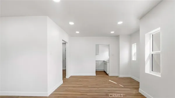 a view of a livingroom with wooden floor and staircase