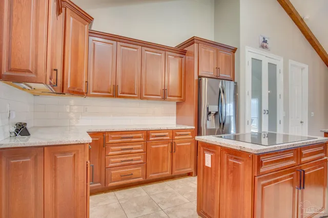 a kitchen with stainless steel appliances granite countertop a refrigerator and cabinets