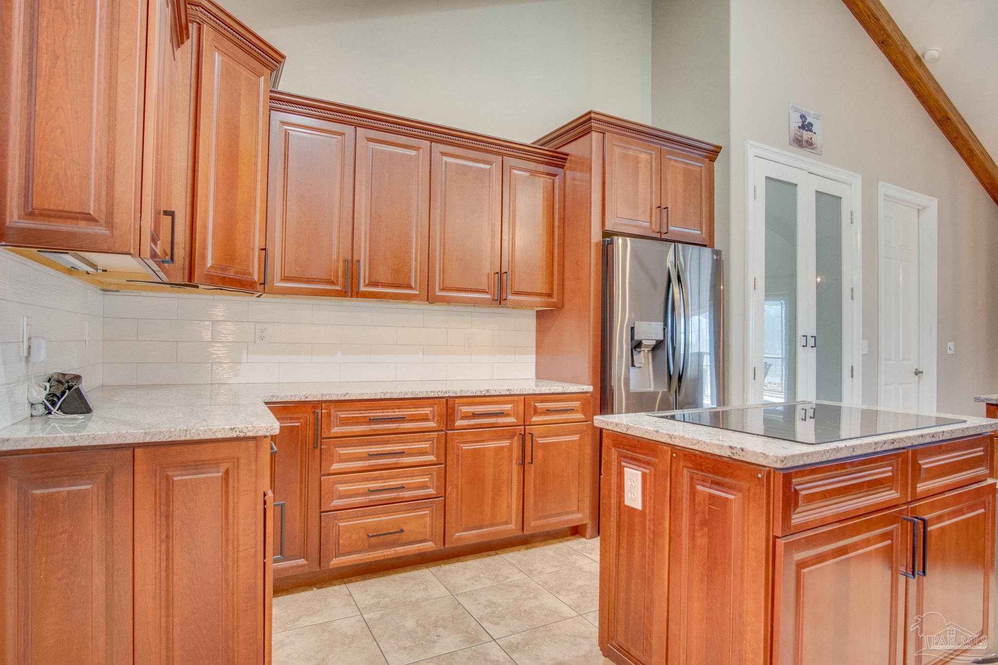 2655 Masters Boulevard Navarre, FL 32566 - Photo 15 of 43 a kitchen with stainless steel appliances granite countertop a refrigerator and cabinets