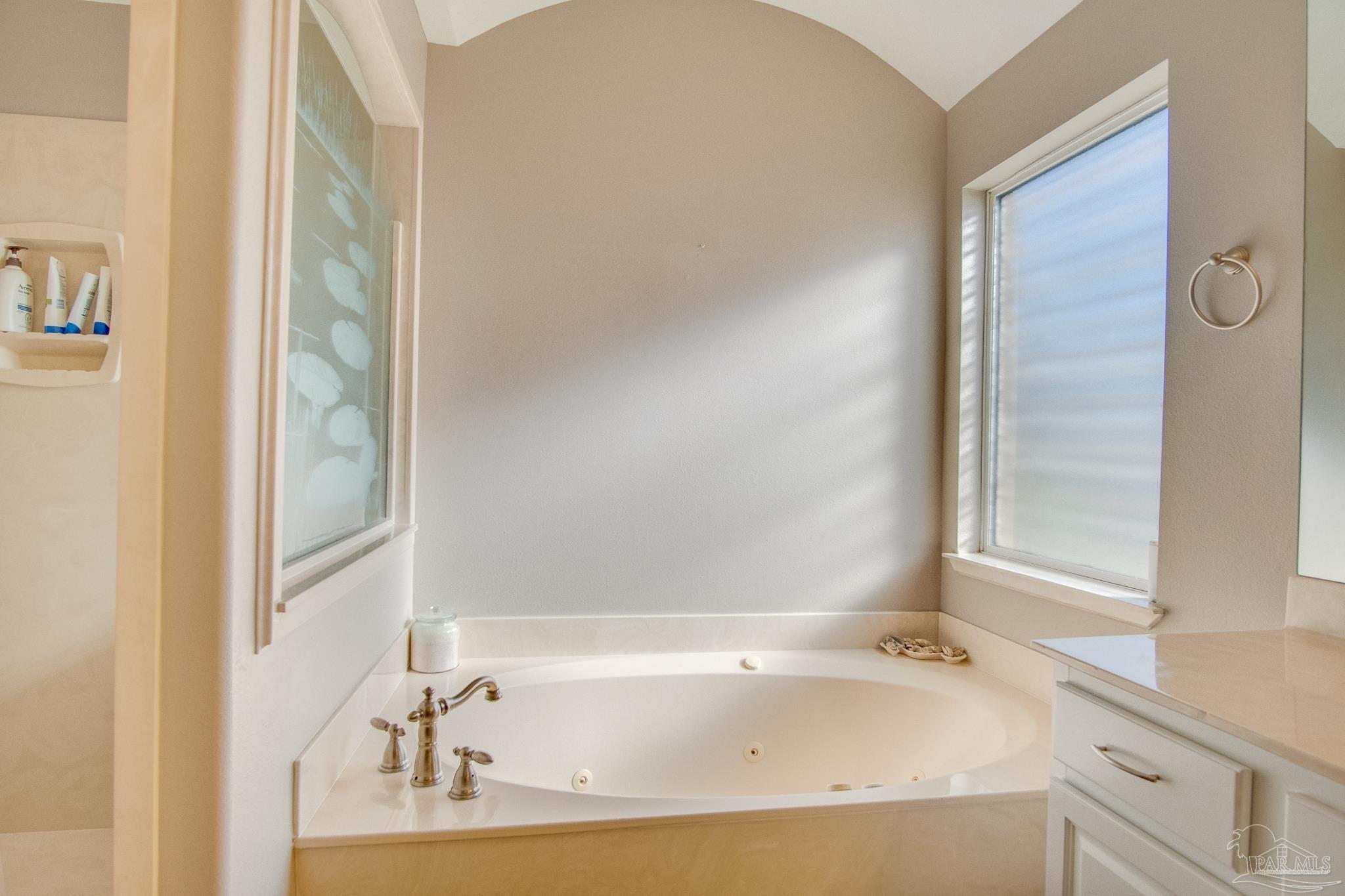 2655 Masters Boulevard Navarre, FL 32566 - Photo 22 of 43 a bathroom with a tub and sink