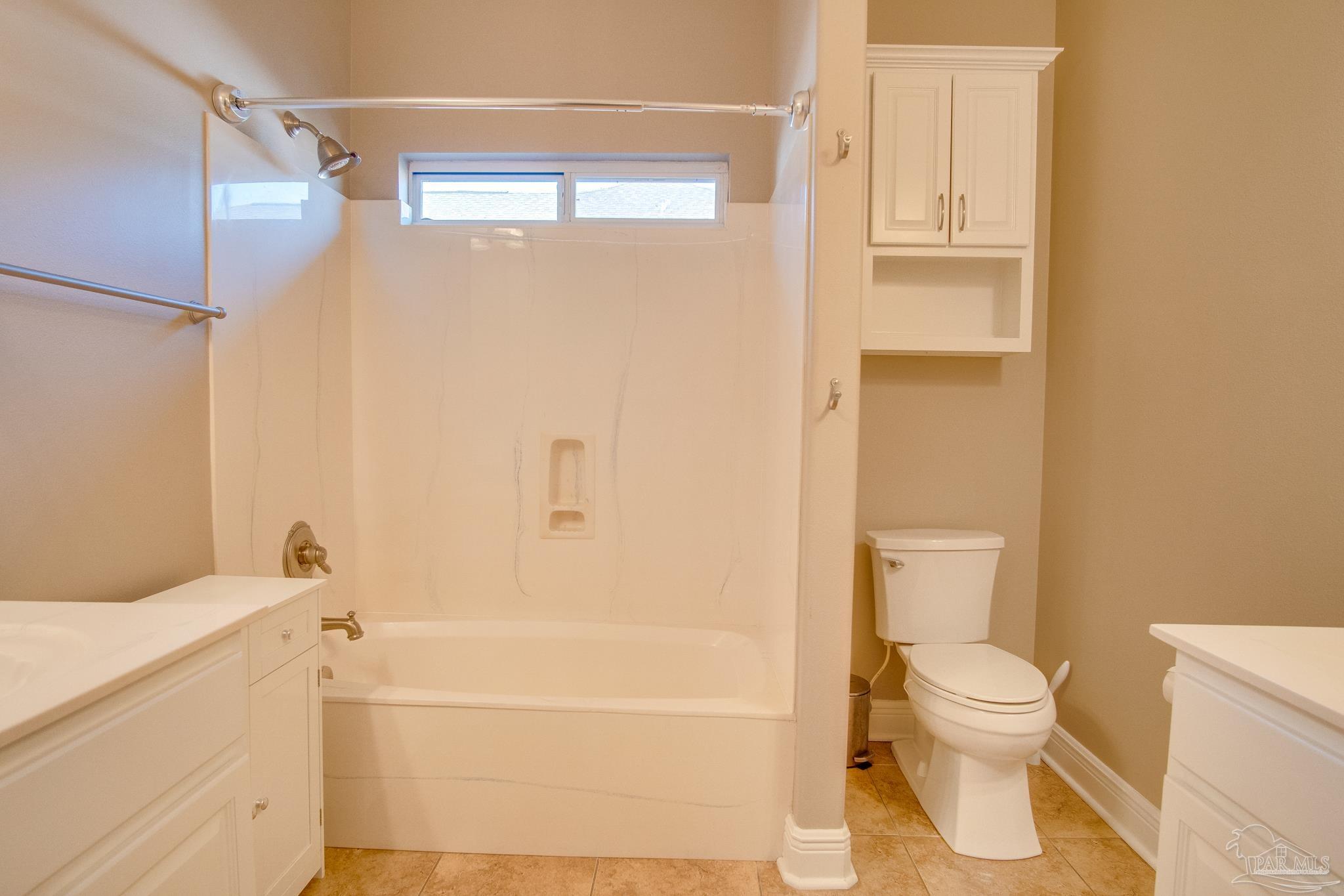2655 Masters Boulevard Navarre, FL 32566 - Photo 25 of 43 a bathroom with a toilet and a shower