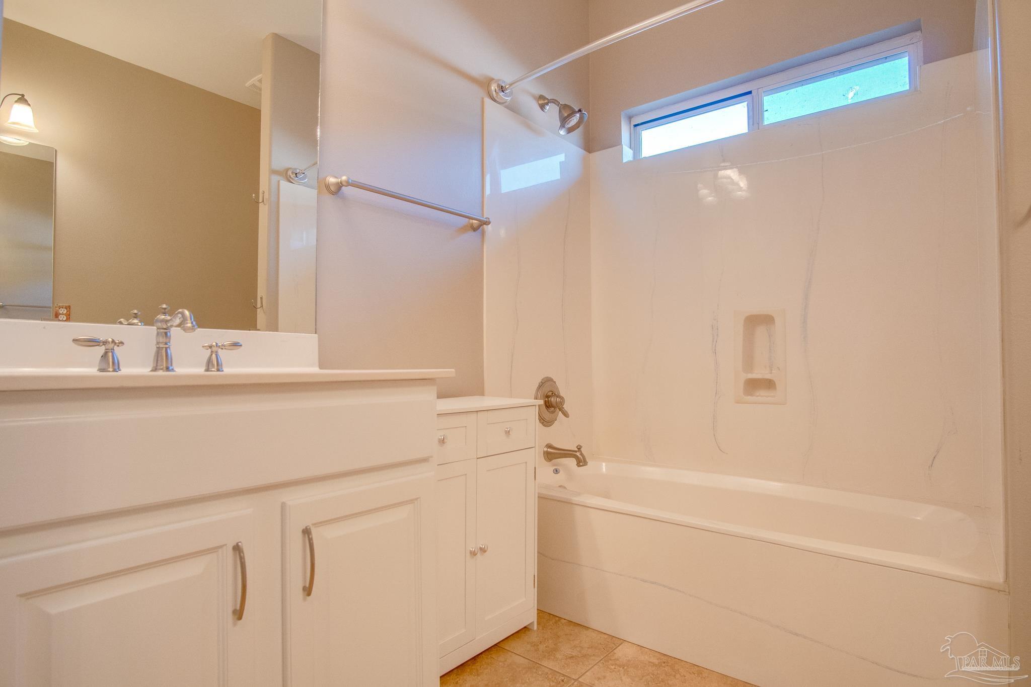 2655 Masters Boulevard Navarre, FL 32566 - Photo 26 of 43 a bathroom with a sink and a mirror