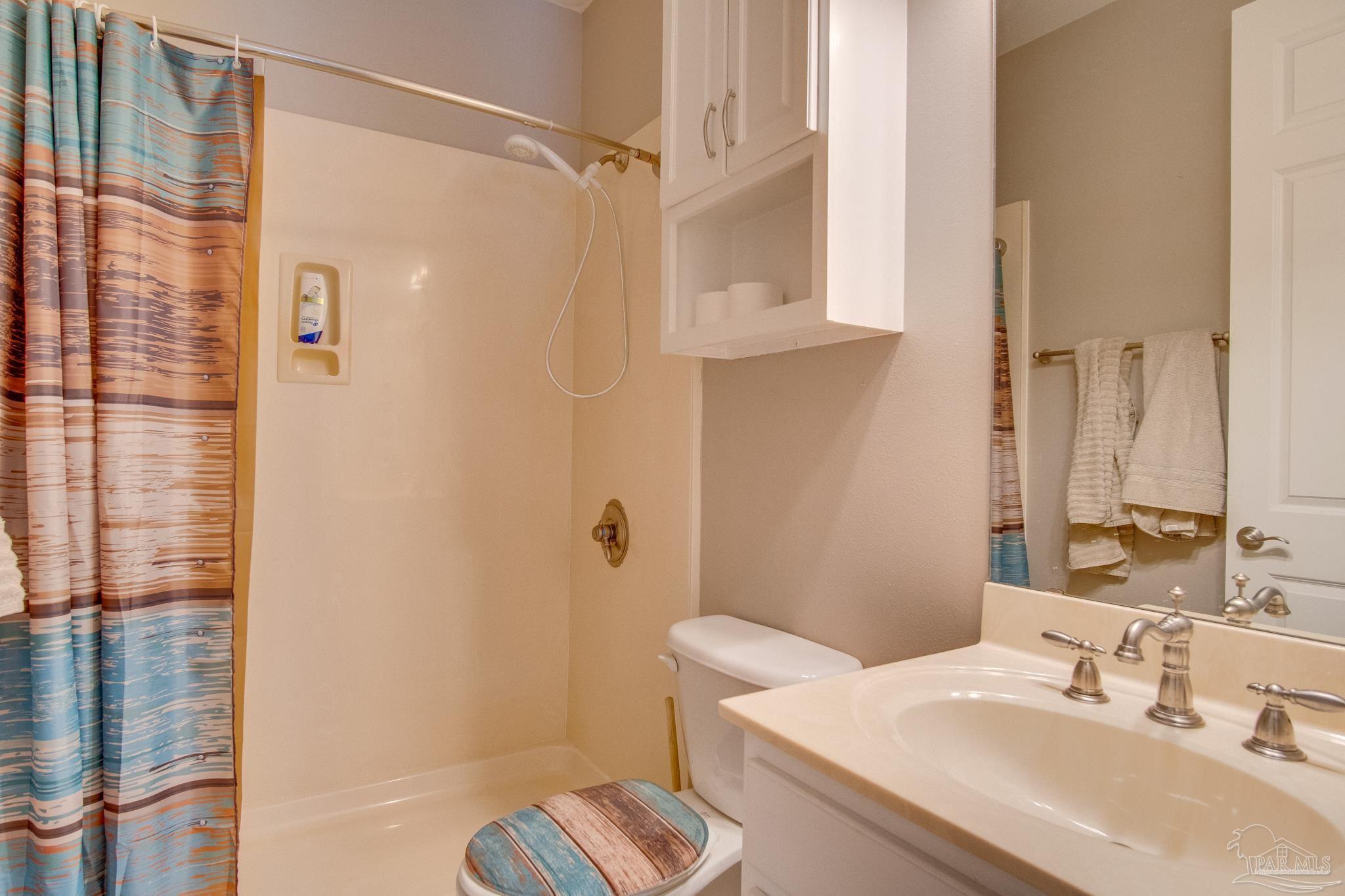 2655 Masters Boulevard Navarre, FL 32566 - Photo 29 of 43 a bathroom with a sink toilet and shower