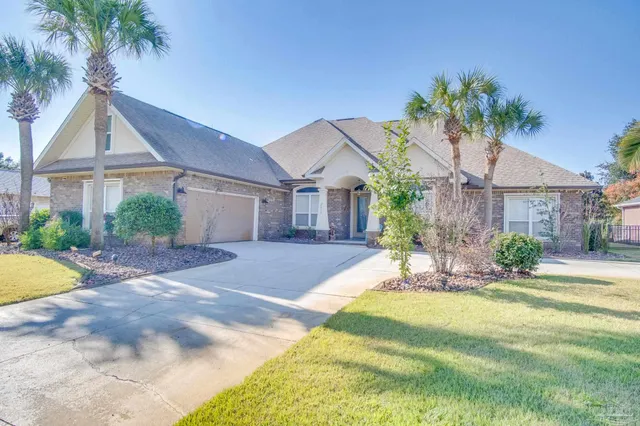 a front view of a house with a yard and palm tree